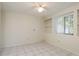 Bedroom with ceiling fan, window with blinds, built-in shelving and tile floor at 399 Walnut Ct, Palm Harbor, FL 34683
