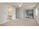 Large main bedroom featuring a ceiling fan, closet doors, and bathroom access at 399 Walnut Ct, Palm Harbor, FL 34683