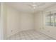 Bedroom with ceiling fan, window with blinds and tile floor at 399 Walnut Ct, Palm Harbor, FL 34683