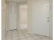 Welcoming entrance foyer with tile flooring, closet, and view into a bright, neutral-toned living space at 399 Walnut Ct, Palm Harbor, FL 34683