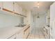 Bright kitchen featuring white appliances and cabinets, with tile flooring and sink with counter at 399 Walnut Ct, Palm Harbor, FL 34683