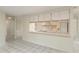 Bright kitchen featuring white cabinets, stainless steel sink and eat-in breakfast bar at 399 Walnut Ct, Palm Harbor, FL 34683