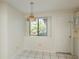 Eat-in kitchen featuring a hanging ceiling light fixture, tiled flooring, and large window at 399 Walnut Ct, Palm Harbor, FL 34683