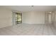 Bright living room showcasing tiled flooring, neutral paint, and sliding glass doors with exterior views at 399 Walnut Ct, Palm Harbor, FL 34683