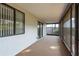 View of a carpeted screened-in porch with views of landscaping at 399 Walnut Ct, Palm Harbor, FL 34683