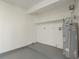 View of a storage room with water heater and shelving at 399 Walnut Ct, Palm Harbor, FL 34683