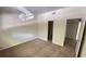 Open bedroom featuring neutral carpeting and an ensuite bathroom at 4003 Oak Limb Ct, Tampa, FL 33614