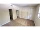 Spacious bedroom with plush carpeting, closet, and a glimpse into a half-bathroom at 4003 Oak Limb Ct, Tampa, FL 33614
