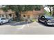 Exterior of a two-story townhome featuring reserved parking, a well-maintained facade, and mature trees at 4003 Oak Limb Ct, Tampa, FL 33614