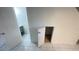 Hallway with tiled floor that leads to a bathroom vanity with storage and a small storage area at 4003 Oak Limb Ct, Tampa, FL 33614