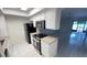 Open kitchen with stainless steel appliances and island cooktop at 4003 Oak Limb Ct, Tampa, FL 33614