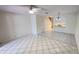 Bright and open living room with tile flooring, ceiling fan, and a glimpse of the staircase at 4003 Oak Limb Ct, Tampa, FL 33614