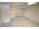 Bright living room with tile flooring and a view into the open-concept kitchen at 4003 Oak Limb Ct, Tampa, FL 33614