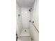Renovated shower with white subway tile, hexagon tile floor, and convenient in-shower niche at 4003 Oak Limb Ct, Tampa, FL 33614