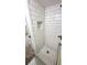 Updated walk-in shower featuring subway tile surround, hexagon tile floor, and a practical shower niche at 4003 Oak Limb Ct, Tampa, FL 33614
