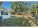 Large backyard featuring mature trees and a well-maintained lawn, perfect for outdoor activities at 4210 Huntington Ne St, St Petersburg, FL 33703