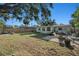 Expansive backyard with mature trees and manicured lawn, offering a private outdoor retreat at 4210 Huntington Ne St, St Petersburg, FL 33703