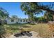 Spacious backyard with a garden and mature trees, offering a serene space for outdoor enjoyment at 4210 Huntington Ne St, St Petersburg, FL 33703