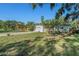 A house sits on a large lot with mature trees and a neatly kept lawn at 4210 Huntington Ne St, St Petersburg, FL 33703