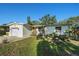 Beautiful one-story home with a manicured lawn, tasteful landscaping, and an attached one-car garage at 4210 Huntington Ne St, St Petersburg, FL 33703
