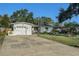 The exterior of the home features a well-manicured lawn, landscaping, and a one-car garage at 4210 Huntington Ne St, St Petersburg, FL 33703