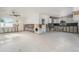 Large living room featuring terrazzo floors, multiple access doors, and natural light at 4210 Huntington Ne St, St Petersburg, FL 33703