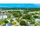 Expansive aerial shot of a neighborhood, highlighting the community pool and surrounding greenery at 4300 16Th N Ave, St Petersburg, FL 33713