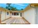 The back patio features a wooden deck and a door that leads to the house interior with natural light at 4300 16Th N Ave, St Petersburg, FL 33713