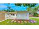 Spacious backyard features lush lawn, stone pathway, and access to the house's back patio at 4300 16Th N Ave, St Petersburg, FL 33713