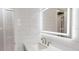 Modern bathroom with white tile, vanity with marble countertop, and illuminated mirror at 4300 16Th N Ave, St Petersburg, FL 33713