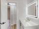 Bright bathroom with white subway tile, modern vanity, and LED mirror at 4300 16Th N Ave, St Petersburg, FL 33713