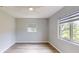 Well-lit bedroom with neutral walls, wood-look flooring, and new windows at 4300 16Th N Ave, St Petersburg, FL 33713