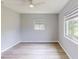 Well-lit bedroom with neutral walls, wood-look flooring, ceiling fan, and new windows at 4300 16Th N Ave, St Petersburg, FL 33713