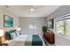 This staged bedroom features neutral walls, a ceiling fan, and art for a cozy and inviting atmosphere at 4300 16Th N Ave, St Petersburg, FL 33713