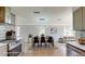 Bright dining room with a modern light fixture, stainless steel appliances, and large windows overlooking the yard at 4300 16Th N Ave, St Petersburg, FL 33713