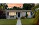 Charming single-story home with well-manicured lawn and blue front door at 4300 16Th N Ave, St Petersburg, FL 33713