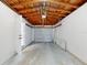 Unfinished garage with door leading to exterior, garage door, and wood beams at 4300 16Th N Ave, St Petersburg, FL 33713