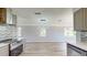 Open kitchen with modern fixtures and finishes connecting to living area; view to landscaped exterior at 4300 16Th N Ave, St Petersburg, FL 33713