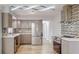 Updated kitchen with stainless steel appliances, quartz countertops, sleek cabinets, and designer lighting at 4300 16Th N Ave, St Petersburg, FL 33713