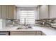 New kitchen sink featuring quartz countertops, stylish backsplash, and stainless steel appliances at 4300 16Th N Ave, St Petersburg, FL 33713