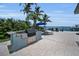 Outdoor kitchen with grill, bar, and water views for seamless outdoor entertaining at 4381 Poinsettia Dr, St Pete Beach, FL 33706
