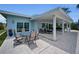 An expansive back patio with a covered seating area, outdoor table, and seamless indoor-outdoor living at 4381 Poinsettia Dr, St Pete Beach, FL 33706