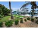 A beautifully landscaped backyard with patio, pool, and manicured lawn at 4381 Poinsettia Dr, St Pete Beach, FL 33706
