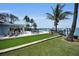 Beautifully landscaped backyard features a putting green, waterfront, and boat lift at 4381 Poinsettia Dr, St Pete Beach, FL 33706