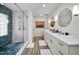 Modern bathroom with double vanity, glass-enclosed shower, and stylish tile flooring at 4381 Poinsettia Dr, St Pete Beach, FL 33706