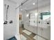 Bright bathroom featuring a glass shower, double vanity, and modern finishes at 4381 Poinsettia Dr, St Pete Beach, FL 33706