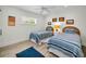 Bedroom featuring two twin beds, wood-look flooring, and bright natural light at 4381 Poinsettia Dr, St Pete Beach, FL 33706