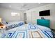Bedroom featuring two beds, sliding closet doors, and a ceiling fan at 4381 Poinsettia Dr, St Pete Beach, FL 33706