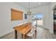 Dining area with rustic wood table, modern chairs, and sliding door access to the patio and water views at 4381 Poinsettia Dr, St Pete Beach, FL 33706