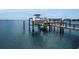 Boat dock with lift providing waterfront access and views of the surrounding coastal scenery at 4381 Poinsettia Dr, St Pete Beach, FL 33706